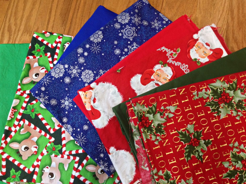 Four print gift wrapping 'sheets' with the intended solid color underneath. I'm not sure if I'll need the solid colors for any gifts this year, so I won't sew them together until next year. 