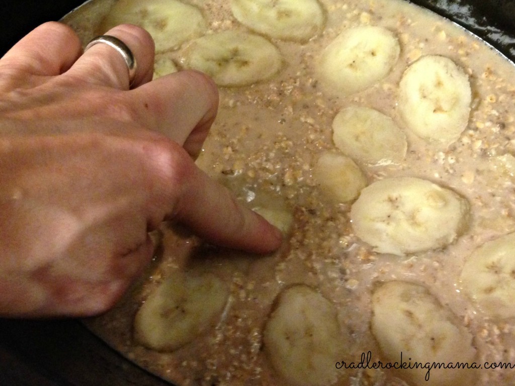 Pressing the banana slices into the mix